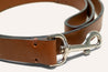 A brown leather Antone's Dog Leash with a metal buckle by Zilker Belts.