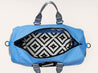 A Zilker Belts blue duffel bag with a black and white pattern.