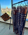 A display of Zilker Belts in front of a city view.