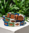 A blue, green, and brown Huck & Harlowe Dog Collar with a buckle from Zilker Belts.