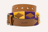 A NOLA belt with a purple, yellow and brown pattern, made by Zilker Belts.