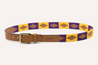 A purple and yellow NOLA belt with a Zilker Belts buckle.
