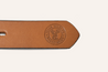 Leather strap with "Texas Wildlife Association (PREORDER)" and a deer logo embossed on it, celebrating conservation efforts, isolated on a white background by Zilker Belts.