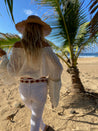 A woman wearing white pants and a straw hat on the beach.
Product Name: Zilker Belts
Brand Name: Native
