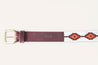 a Zilker Belts ATX Dark belt with an orange and brown design on it.