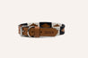 Dark brown leather dog collar with black and white stitching. Zilker Belt logo embossing.