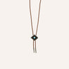 A Zilker Bolo Tie with a turquoise stone on it.