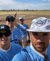 A group of Zilker Belts baseball players posing for a photo with their Moontowers.