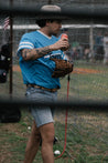 A man wearing Moontowers shorts and a Zilker Belts baseball mitt.