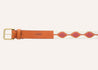 A Native belt with an orange and pink pattern by Zilker Belts.