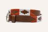A brown leather belt with a white and orange ATX Kids pattern, made by Zilker Belts.