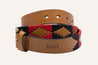 A Red River belt with a red and black pattern from Zilker Belts.
